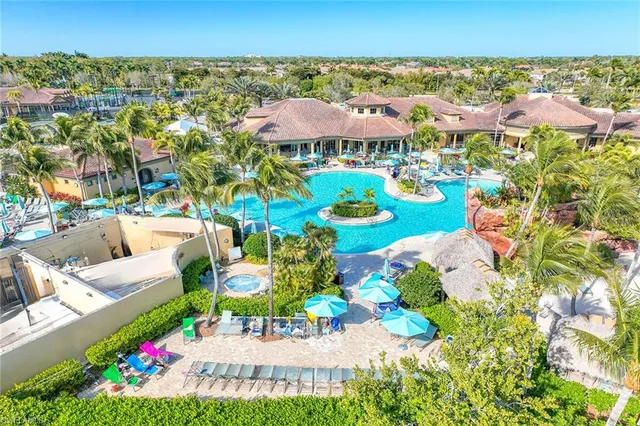 a view of a swimming pool with lawn chairs