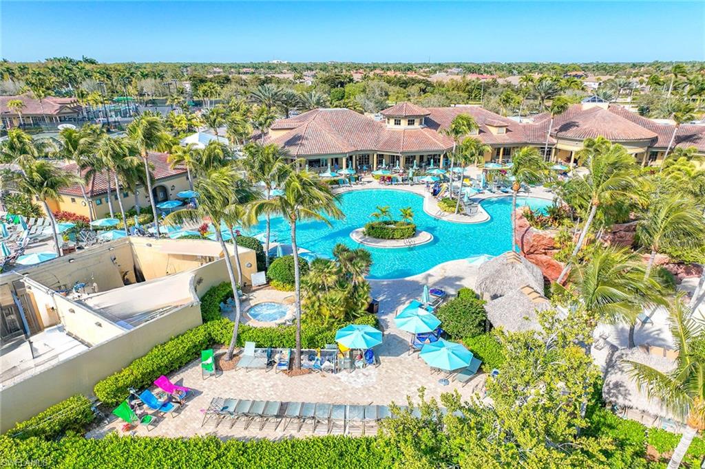 6864 Ascot Drive, Unit 5202 Naples, FL 34113 - Photo 35 of 36 a view of a swimming pool with lawn chairs
