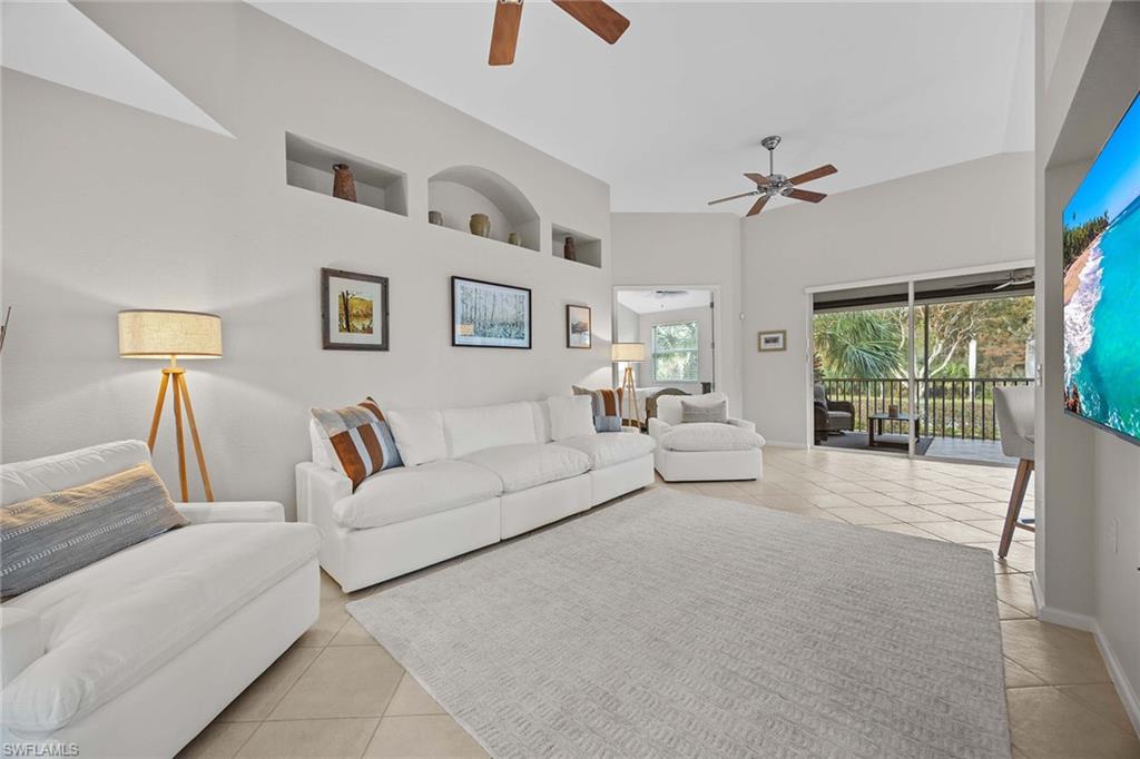 6864 Ascot Drive, Unit 5202 Naples, FL 34113 - Photo 7 of 36 a living room with furniture and a large window