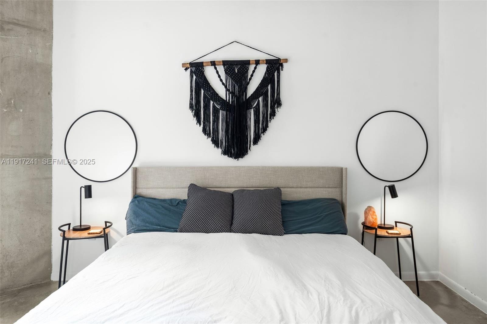 2001 Biscayne Boulevard, Unit 2409 Miami, FL 33137 - Photo 13 of 48 a bedroom with bed and a chandelier