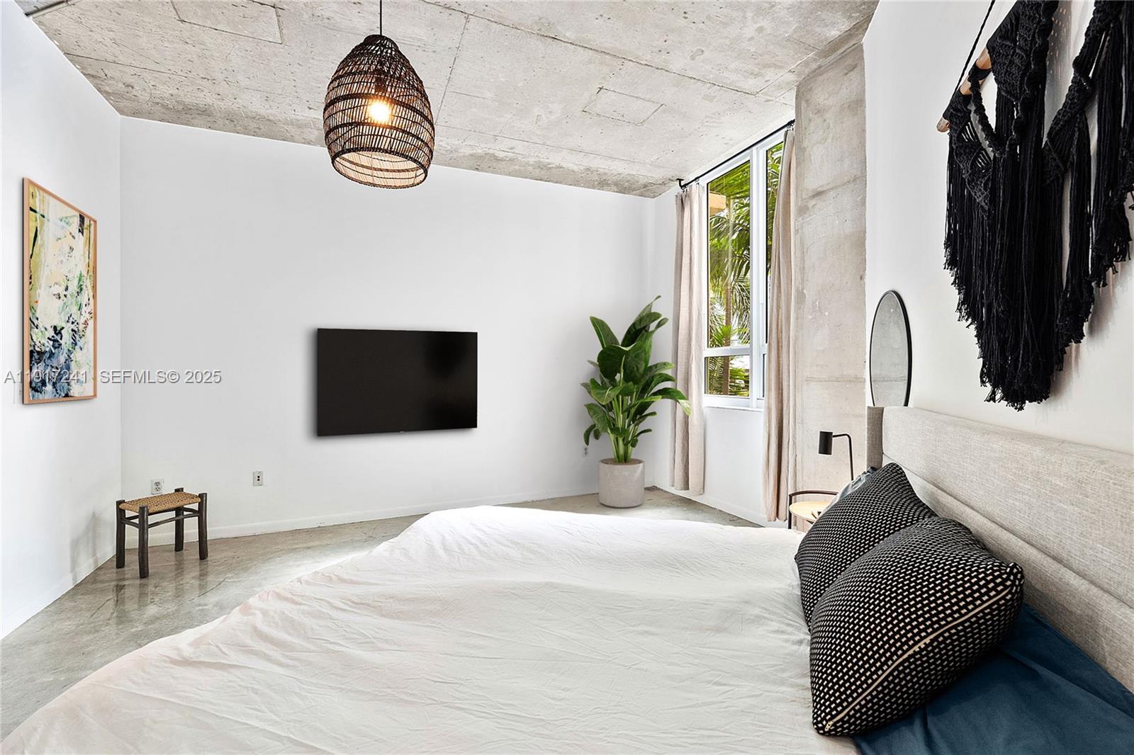 2001 Biscayne Boulevard, Unit 2409 Miami, FL 33137 - Photo 14 of 48 a bedroom with a bed a flat screen tv and a window