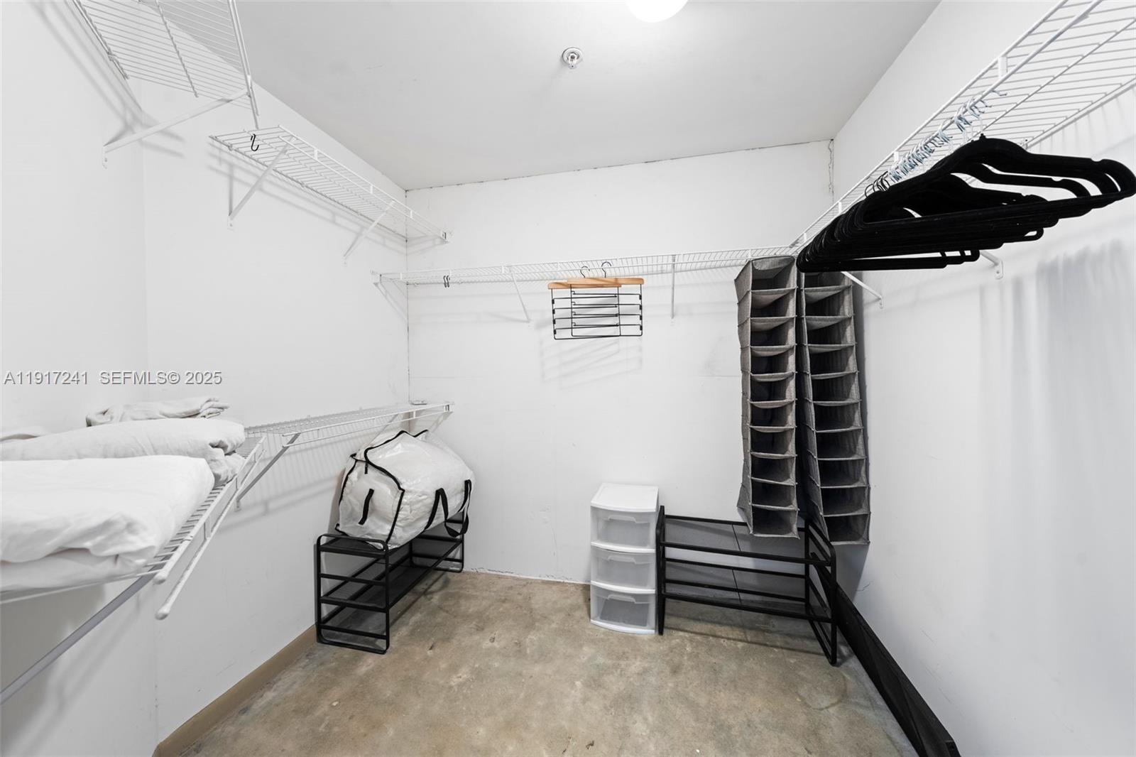 2001 Biscayne Boulevard, Unit 2409 Miami, FL 33137 - Photo 16 of 48 a bedroom with a bed and a window