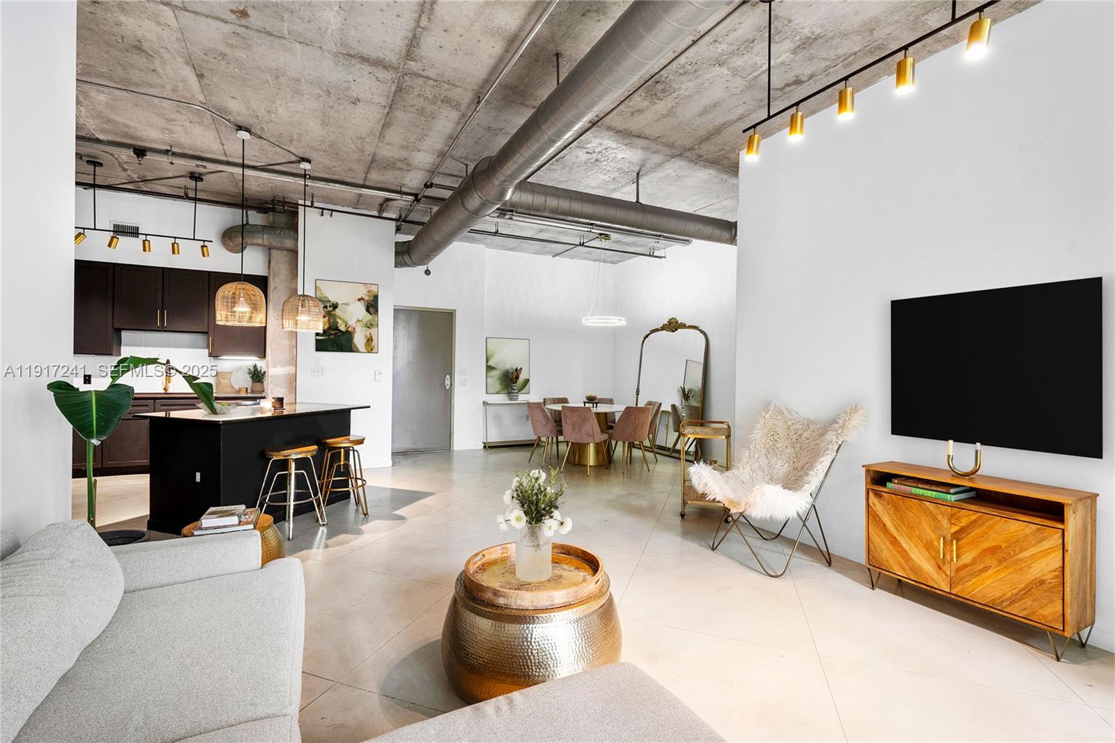 2001 Biscayne Boulevard, Unit 2409 Miami, FL 33137 - Photo 9 of 48 a living room with furniture and a flat screen tv