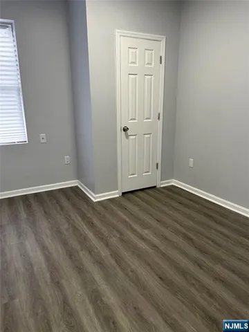 a view of wooden floor and windows in a room