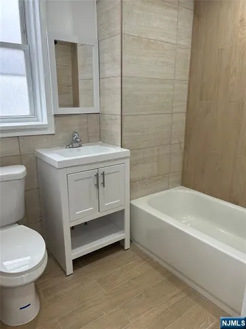 a bathroom with a sink a toilet and bathtub