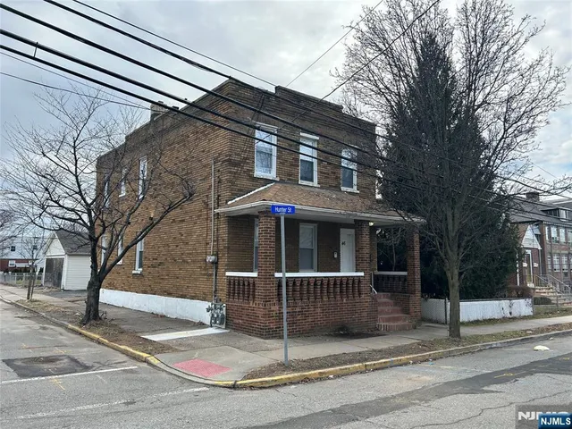 a view of a house with a large tree