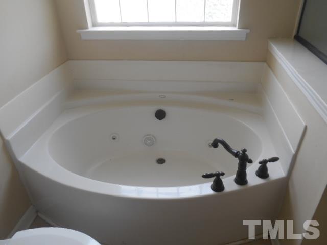 6131 Ricker Road Raleigh, NC 27610 - Photo 11 of 15 a bathroom with a bathtub