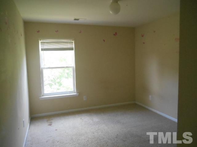 6131 Ricker Road Raleigh, NC 27610 - Photo 12 of 15 an empty room with a window