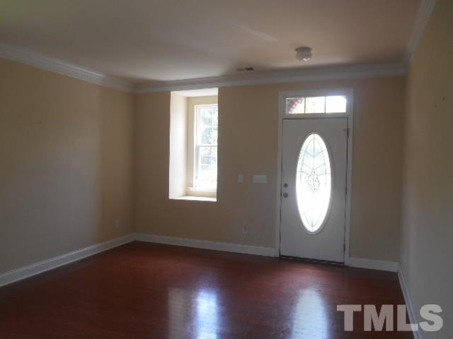 6131 Ricker Road Raleigh, NC 27610 - Photo 5 of 15 an empty room with wooden floor and windows