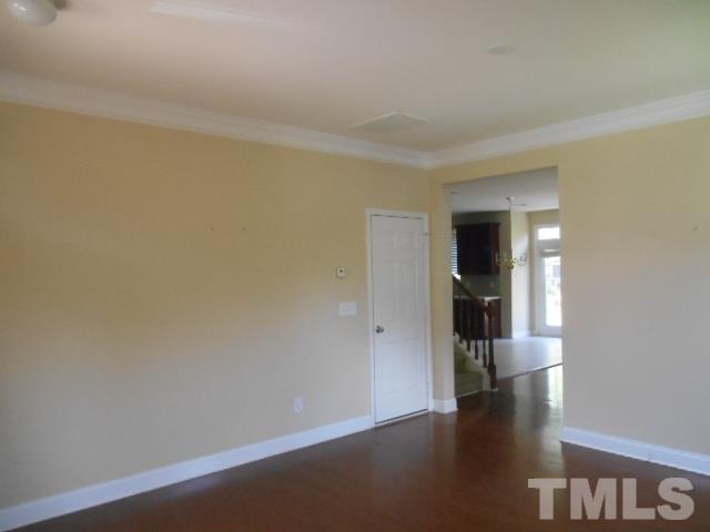 6131 Ricker Road Raleigh, NC 27610 - Photo 6 of 15 a view of hallway with stairs and wooden floor