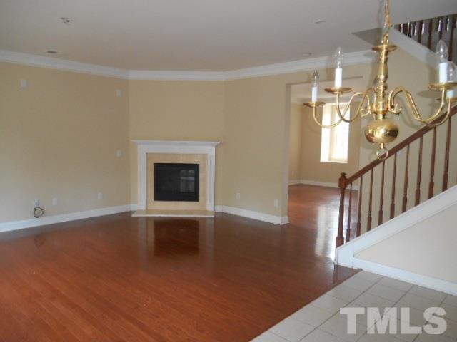 6131 Ricker Road Raleigh, NC 27610 - Photo 8 of 15 wooden floor in an empty room with a window