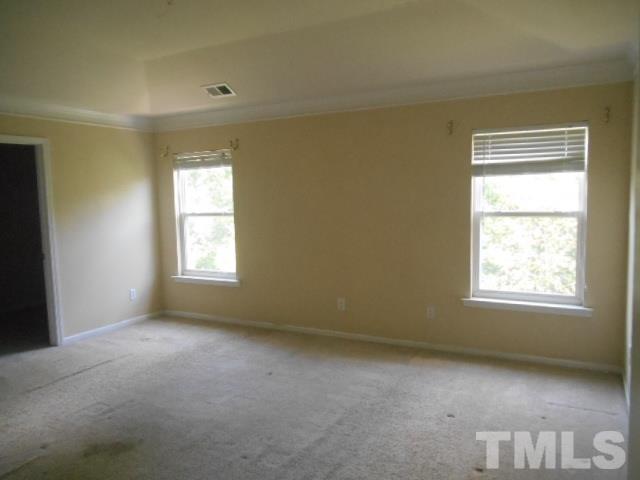 6131 Ricker Road Raleigh, NC 27610 - Photo 10 of 15 an empty room with a window