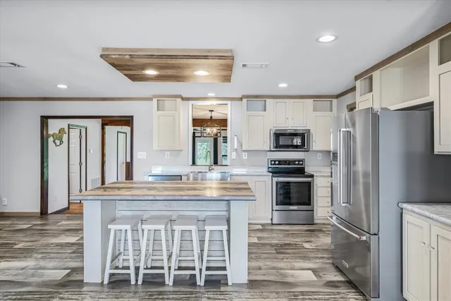 a kitchen with stainless steel appliances granite countertop a refrigerator and a stove