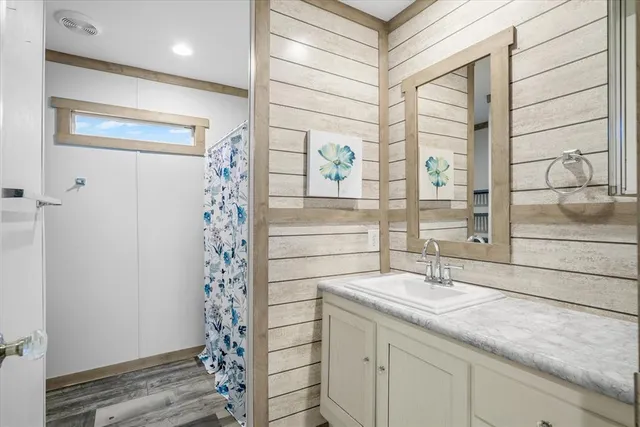 a view of a room with wooden floor and a ceiling fan