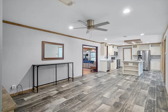 a view of a livingroom with wooden floor and a window