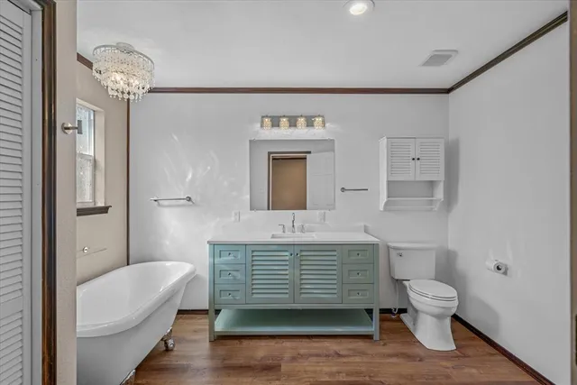 a bathroom with a double vanity sink toilet mirror and bathtub