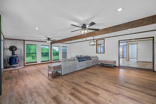 a living room with furniture and large windows