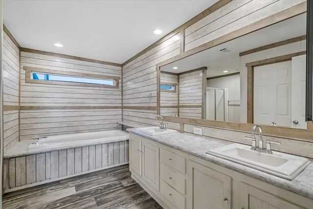 a bathroom with a double vanity sink and a mirror