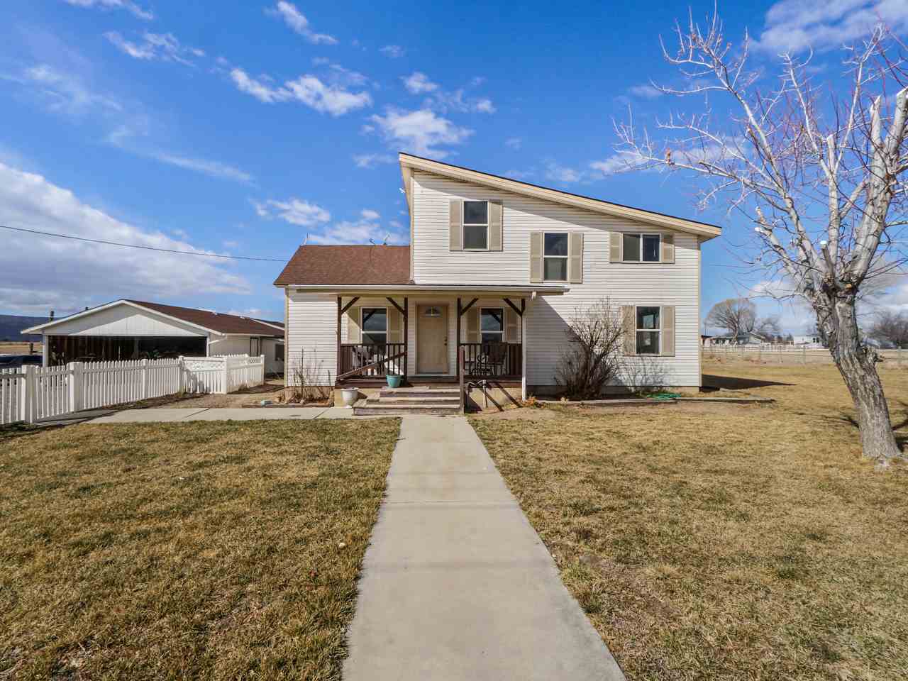 1195 19 Road Fruita, CO 81521 - Photo 3 of 31 a front view of a house with a yard