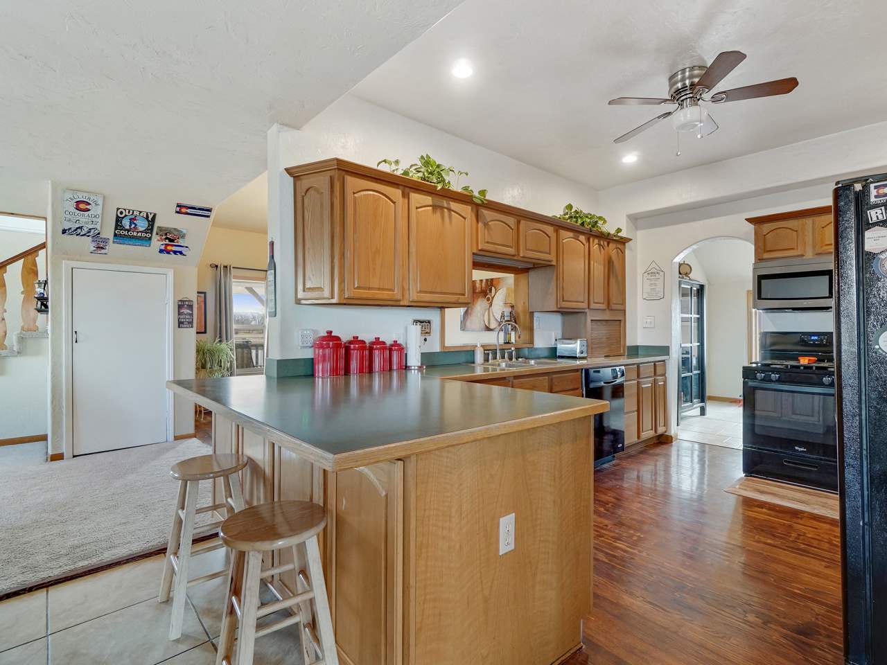 1195 19 Road Fruita, CO 81521 - Photo 6 of 31 a kitchen with stainless steel appliances granite countertop a refrigerator a sink dishwasher and a stove with wooden floor