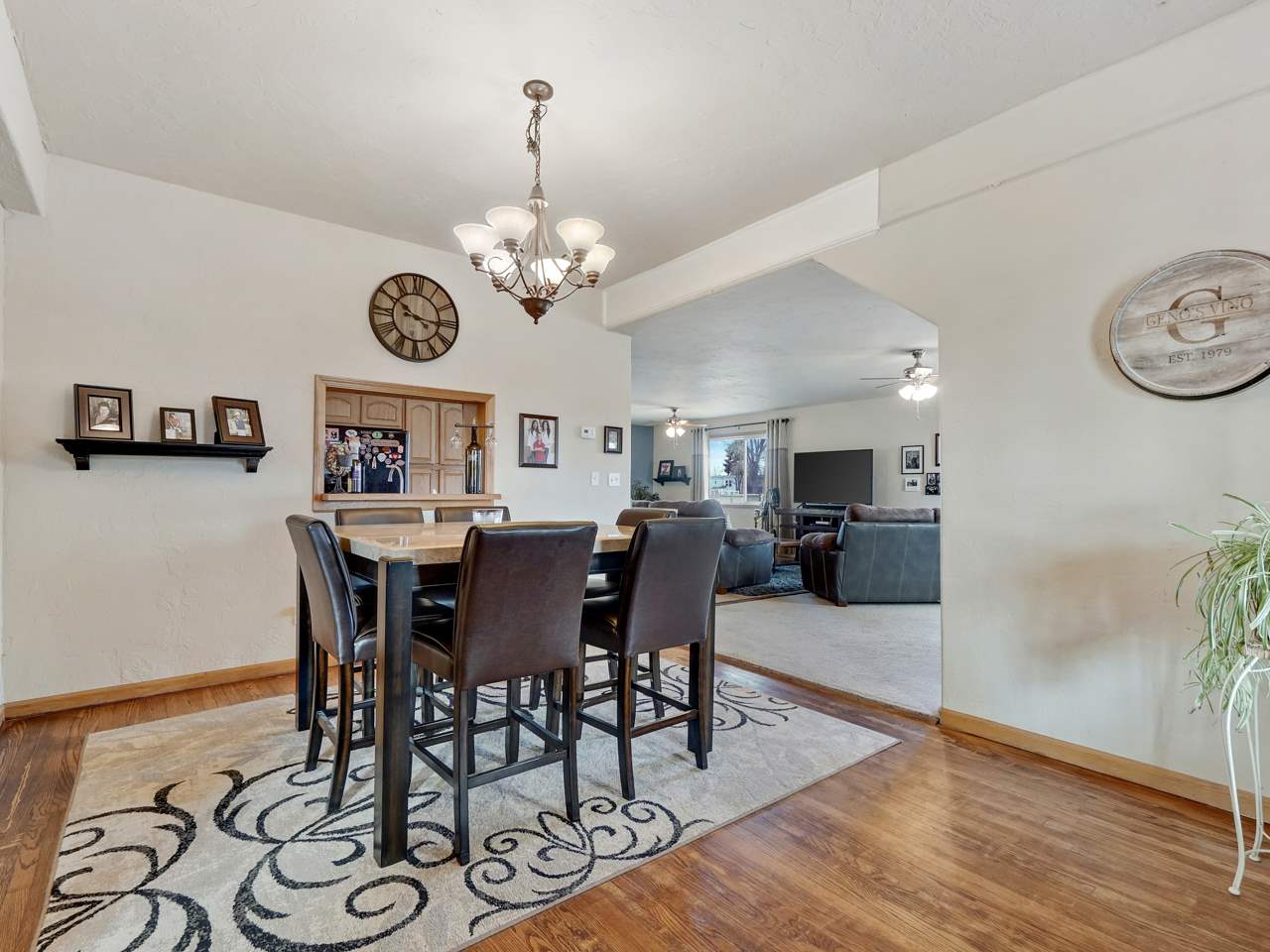 1195 19 Road Fruita, CO 81521 - Photo 10 of 31 a view of a dining room and livingroom with furniture wooden floor a rug a painting and a chandelier