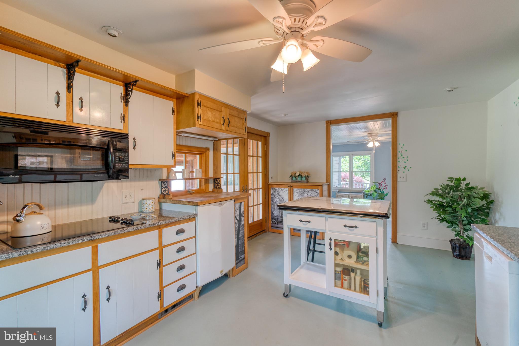 1728 Appleton Road Elkton, MD 21921 - Photo 16 of 36 a kitchen with stainless steel appliances kitchen island granite countertop a stove a sink and a refrigerator