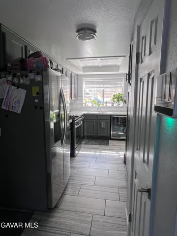 a room with lots of appliances and cabinets