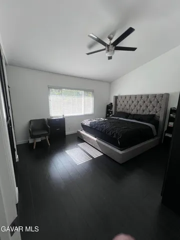 a living room with furniture and a ceiling fan