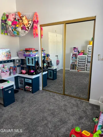 a room with toys and a potted plant