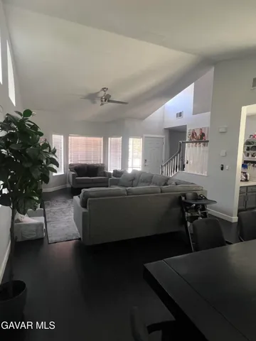 a living room with furniture and a potted plant