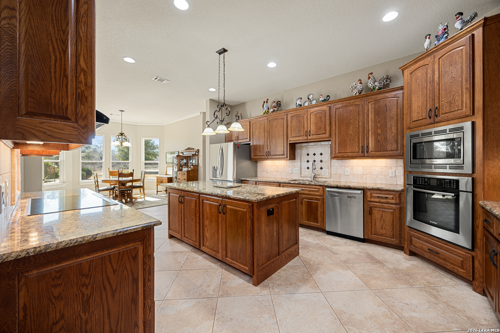 133 Vintage Ranch Circle La Vernia, TX 78121 - Photo 13 of 48 a large kitchen with stainless steel appliances granite countertop a stove oven and a sink