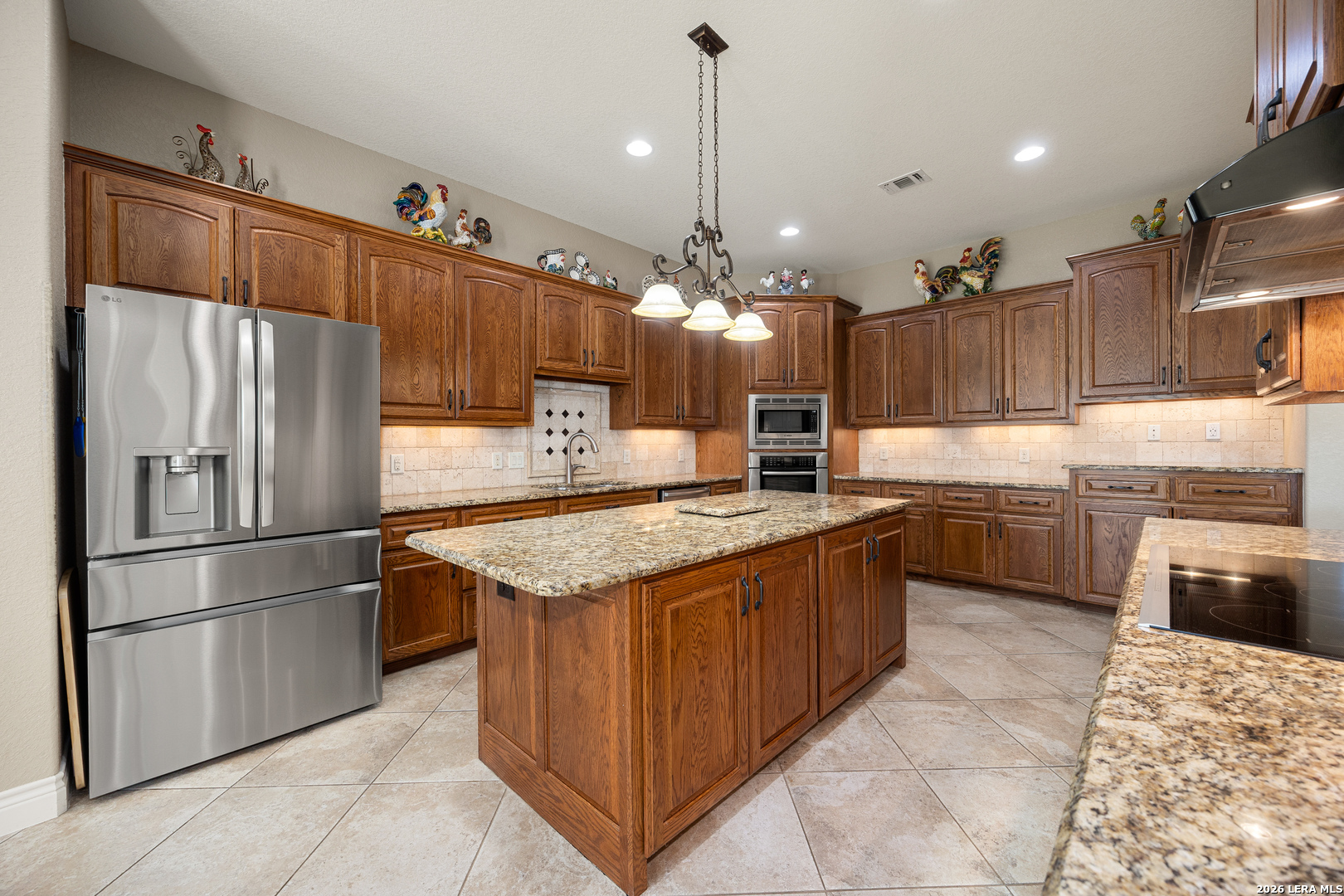 133 Vintage Ranch Circle La Vernia, TX 78121 - Photo 14 of 48 a kitchen with kitchen island a sink stainless steel appliances and cabinets