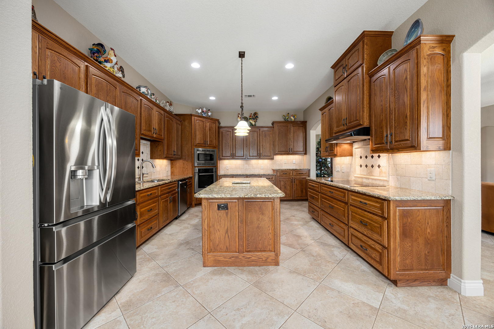 133 Vintage Ranch Circle La Vernia, TX 78121 - Photo 15 of 48 a kitchen with stainless steel appliances granite countertop a refrigerator a sink and a stove
