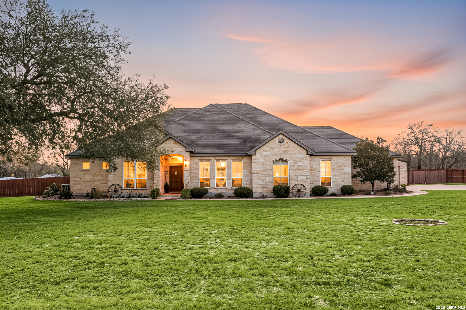 133 Vintage Ranch Circle La Vernia, TX 78121 - Photo 2 of 48 a big house with a big yard and large trees
