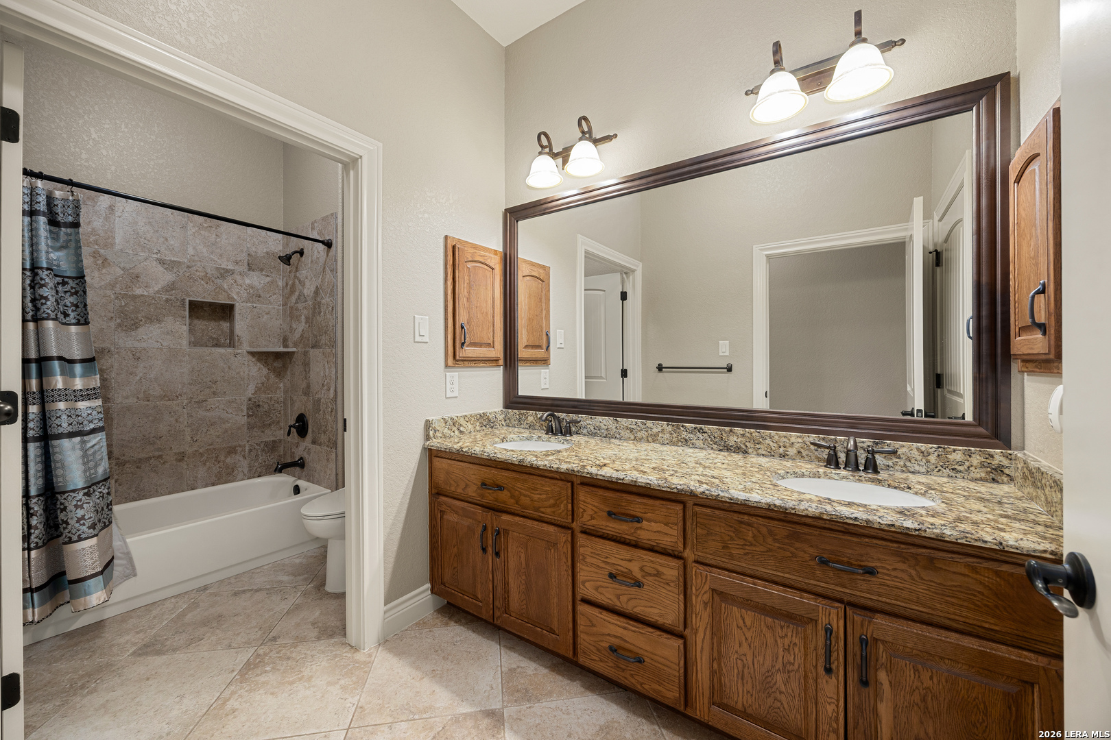 133 Vintage Ranch Circle La Vernia, TX 78121 - Photo 21 of 48 a bathroom with a tub a sink and mirror