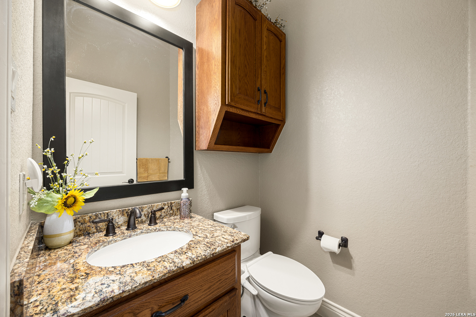 133 Vintage Ranch Circle La Vernia, TX 78121 - Photo 22 of 48 a bathroom with a granite countertop toilet sink and mirror