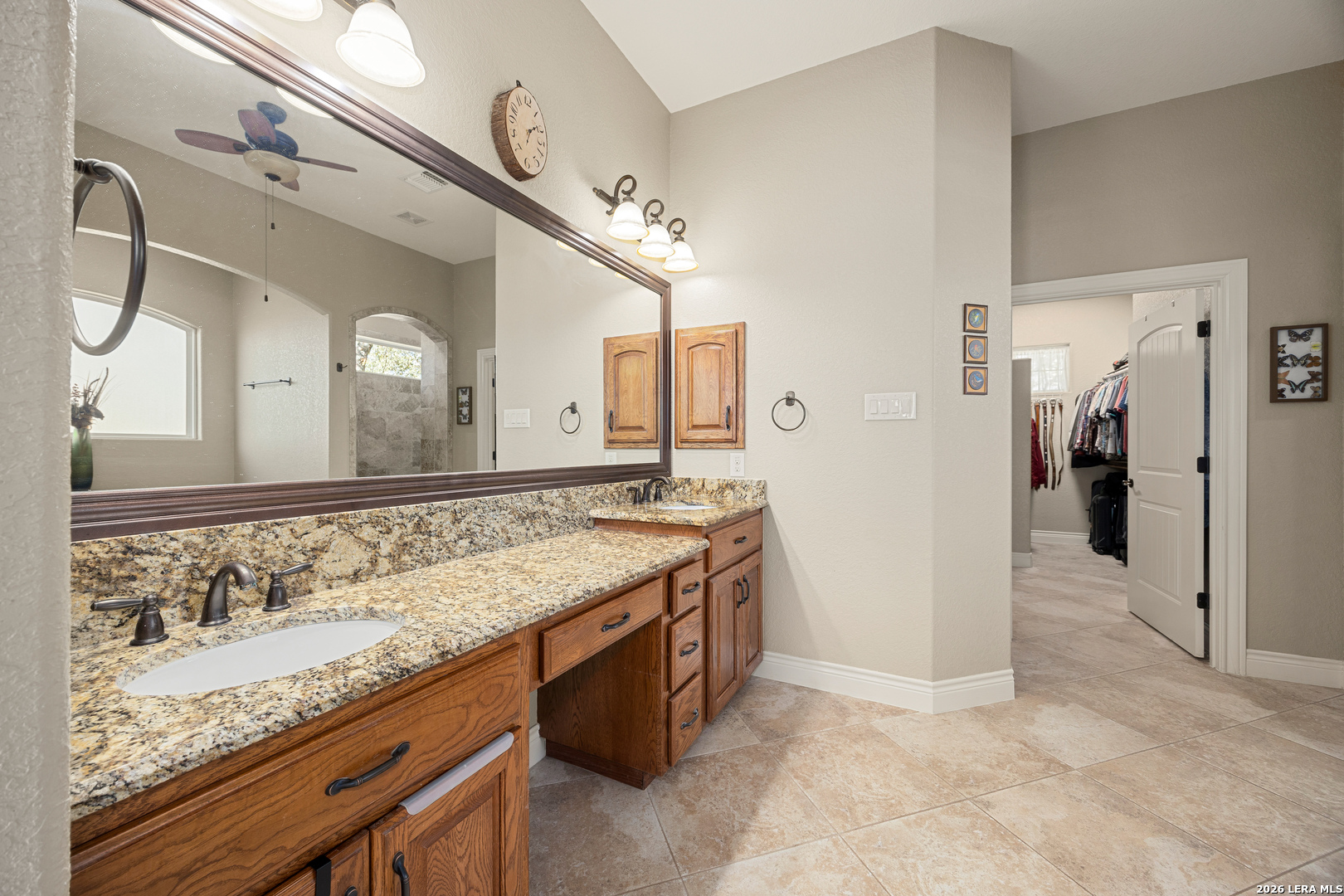133 Vintage Ranch Circle La Vernia, TX 78121 - Photo 25 of 48 a bathroom with a granite countertop double vanity sink and a mirror