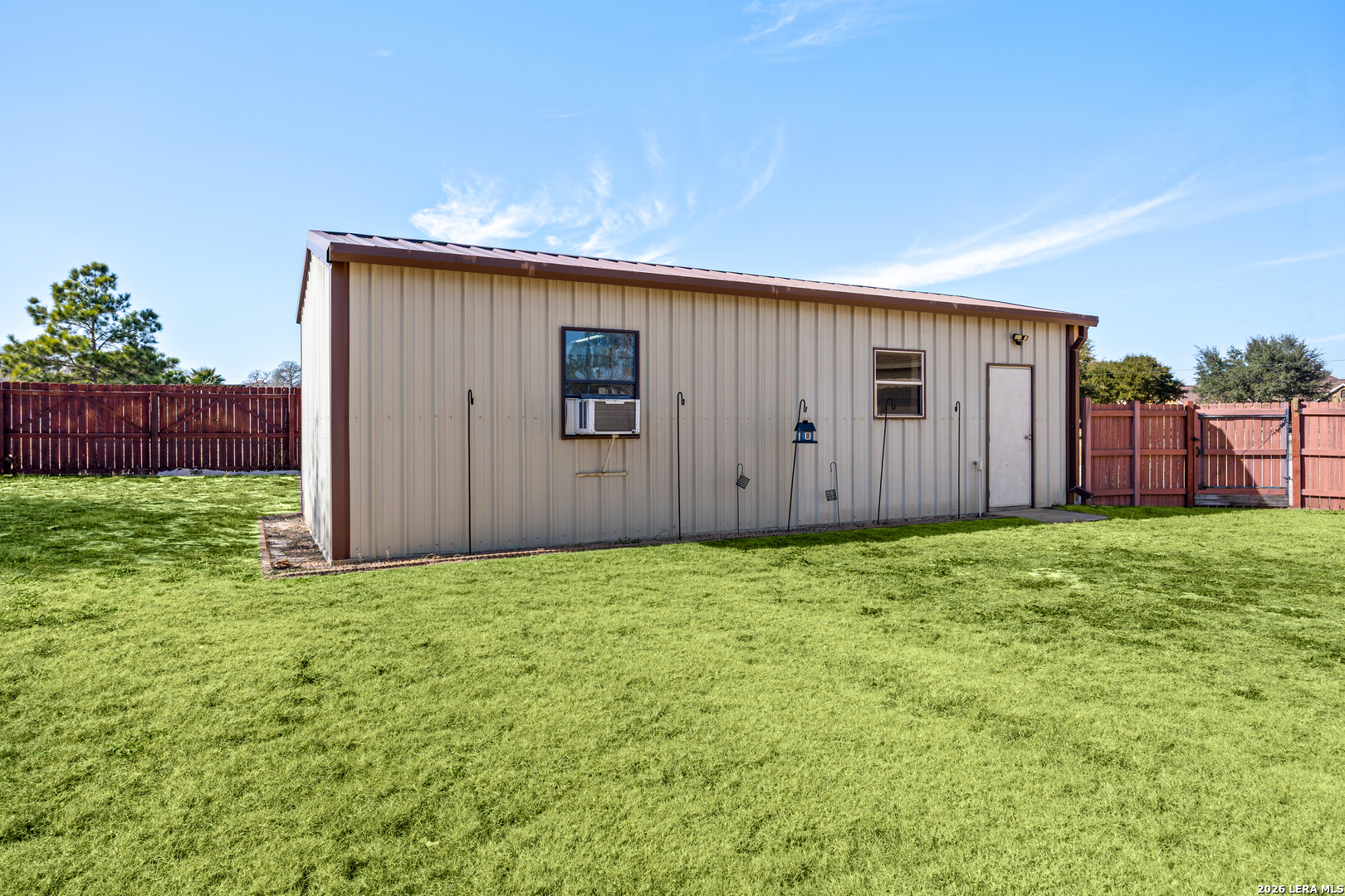 133 Vintage Ranch Circle La Vernia, TX 78121 - Photo 44 of 48 a view of a backyard with potted plants and wooden fence