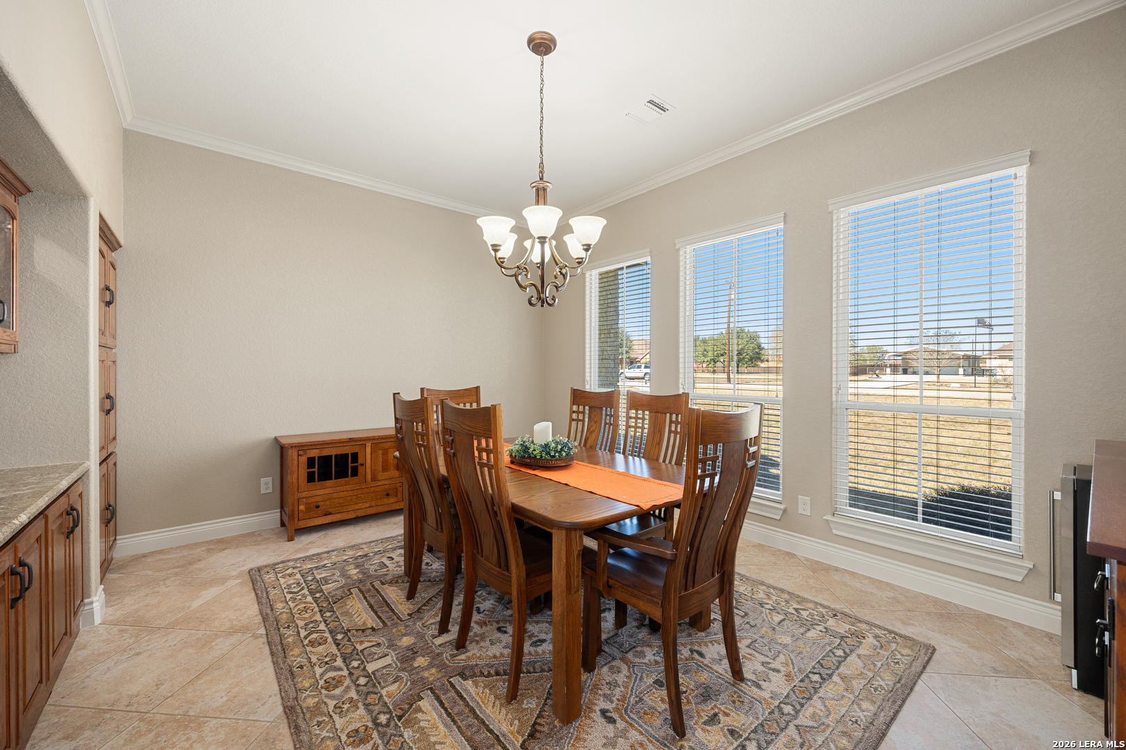133 Vintage Ranch Circle La Vernia, TX 78121 - Photo 10 of 48 a dining room with furniture a rug a potted plant and a chandelier