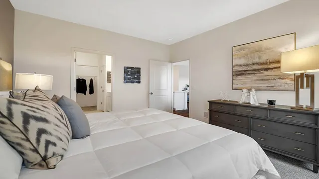 a bedroom with a bed and a dresser