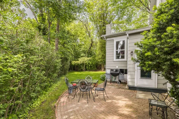 a view of a house with backyard sitting area and garden