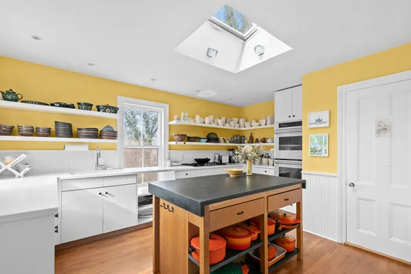 a kitchen with a sink stove and cabinets