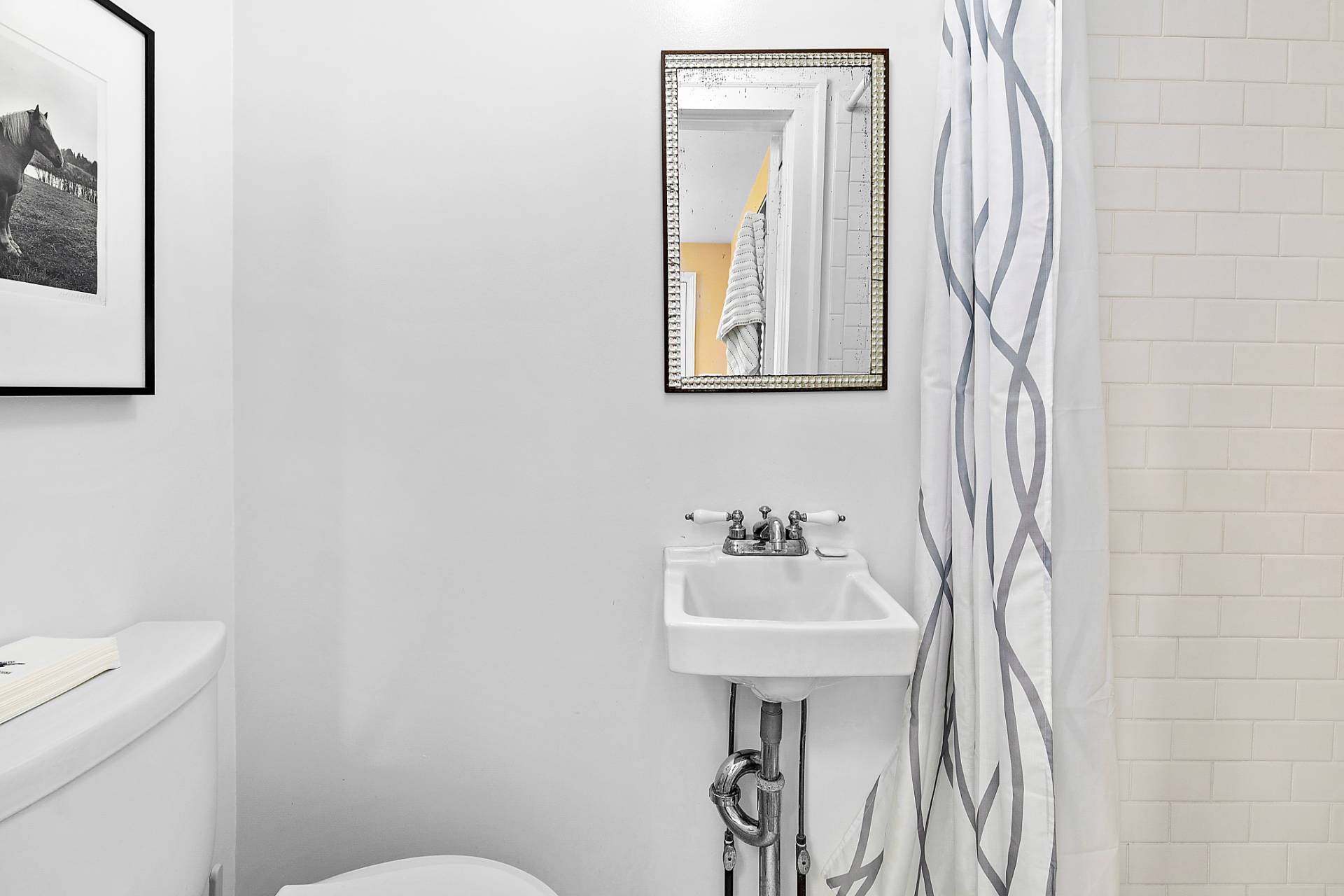 Undisclosed Address Sag Harbor, NY 11963 - Photo 7 of 14 a bathroom with a sink a toilet and mirror