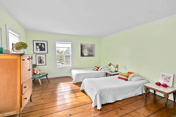 a bedroom with furniture and a wooden floor