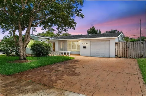 a view of a house with a yard and garage