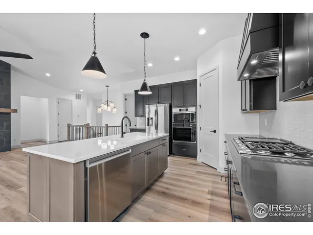 a kitchen with stainless steel appliances kitchen island a sink appliances and cabinets