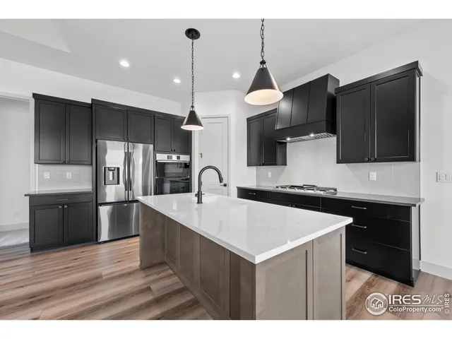 a kitchen with stainless steel appliances a sink stove and refrigerator
