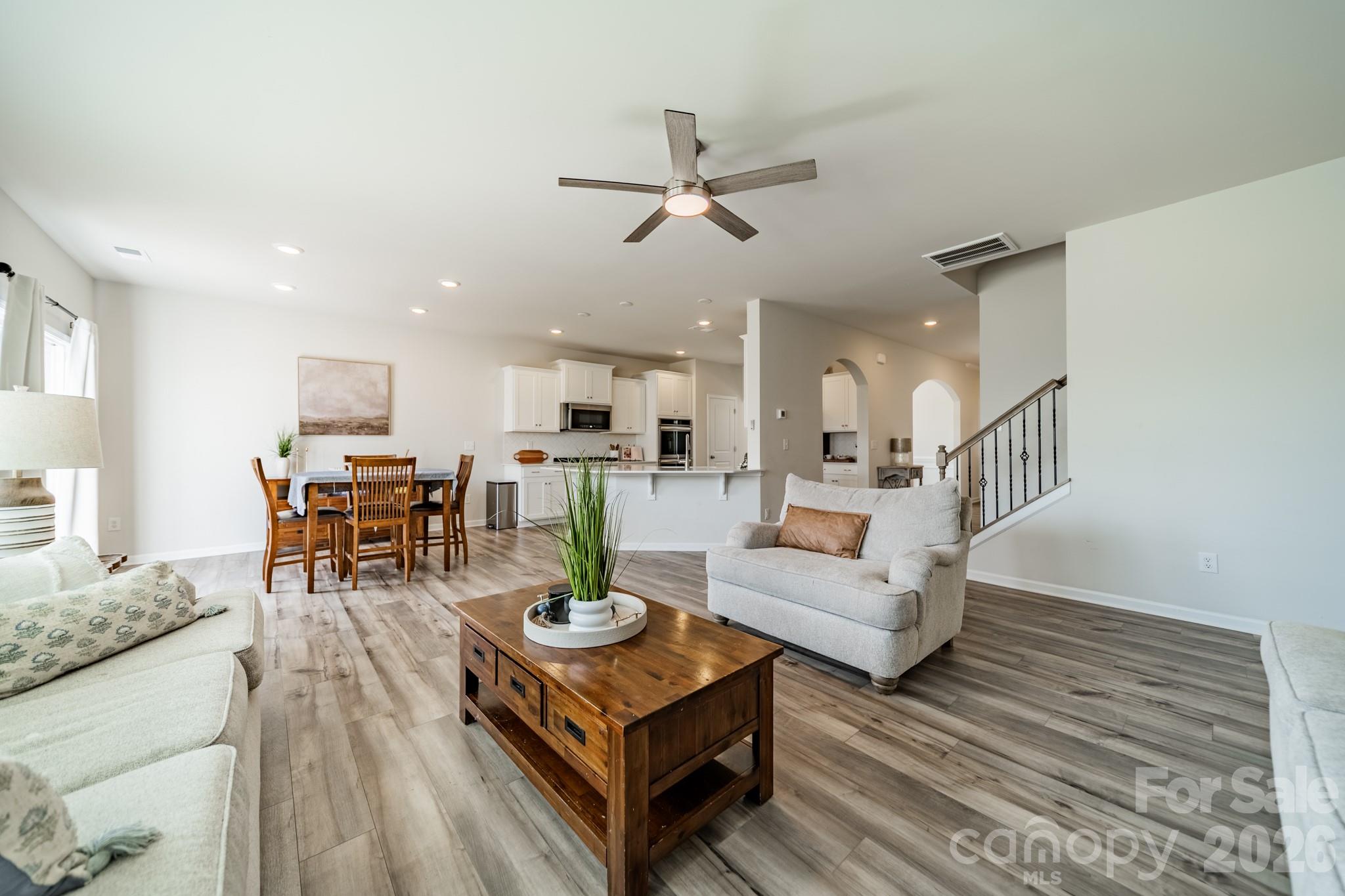 5542 Soft Shell Drive Lancaster, SC 29720 - Photo 13 of 43 a living room with furniture kitchen view and a wooden floor