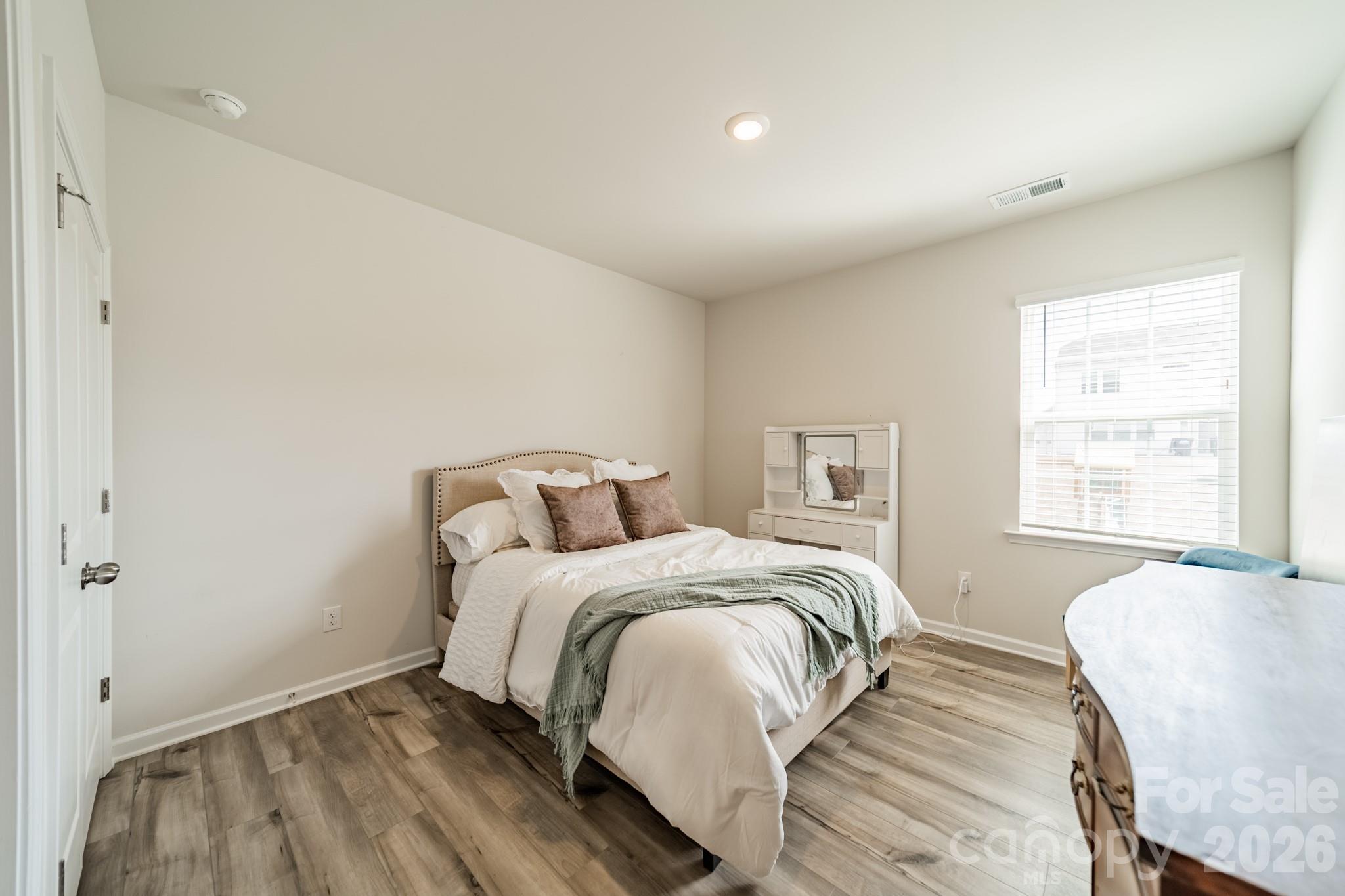 5542 Soft Shell Drive Lancaster, SC 29720 - Photo 16 of 43 a bedroom with a bed and wooden floor