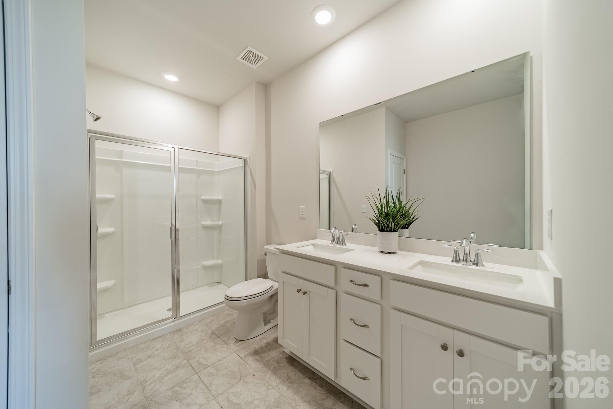 5542 Soft Shell Drive Lancaster, SC 29720 - Photo 17 of 43 a bathroom with a double vanity sink toilet and shower